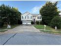 Two-story home with two-car garage, stone facade, and landscaped front yard at 1047 Martin Heights Dr, Lawrenceville, GA 30044