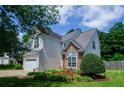 Well-maintained home with stone accents, lush landscaping, and a fenced backyard at 348 Weatherstone Place Pl, Woodstock, GA 30188