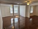 Bright living room featuring beautiful hardwood floors, white walls, and an open floor plan at 6261 Pinegrove Rd, Riverdale, GA 30274