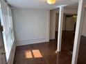Bright living room featuring beautiful hardwood floors, white walls, and window blinds at 6261 Pinegrove Rd, Riverdale, GA 30274