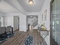 Inviting foyer with hardwood floors, elegant lighting, and a view of the staircase at 2260 Cedar Place Ct, Snellville, GA 30078