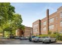 Brick apartment building surrounded by mature trees and a parking lot at 1041 State Nw St # 23, Atlanta, GA 30318