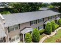Well-maintained townhome exterior featuring lush landscaping and a new roof at 2232 Dunseath Ave # 407, Atlanta, GA 30318
