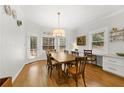 Bright dining room with hardwood floors, large windows, and an adjacent built-in desk area at 4250 Green Ridge Ne Dr, Marietta, GA 30062