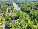 Aerial view of the home's location near a lake surrounded by dense trees and lush green landscape at 2945 Cardinal Lake Cir, Duluth, GA 30096