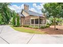 The home features a screened-in porch, mature trees, and lush landscaping at 3178 Kenna Nw Dr, Acworth, GA 30101