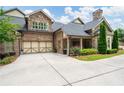 Charming brick home boasts a two-car garage, stone accents, manicured landscaping, and a welcoming covered entrance at 3178 Kenna Nw Dr, Acworth, GA 30101