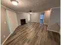 Open-concept living room boasts wood-look floors, a cozy fireplace, and bright natural light at 6353 Wedgeview Ct, Tucker, GA 30084