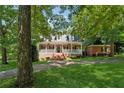 Beautiful brick home with covered porch, lush lawn, and mature trees at 4200 E 166 Hwy, Carrollton, GA 30116