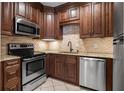 Well-equipped kitchen with stainless steel appliances, granite countertops, and beautiful wood cabinets at 1421 Peachtree Ne St # 310, Atlanta, GA 30309
