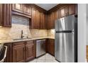 Efficient kitchen with stainless steel appliances, granite countertops, and wood cabinets at 1421 Peachtree Ne St # 310, Atlanta, GA 30309