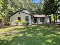 Well-manicured lawn and landscaping complement this home's white exterior and inviting front porch at 1771 Kristi Dr, Lawrenceville, GA 30043