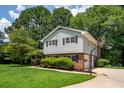 Two-story home with attached garage and basketball hoop on a lush green lawn at 1831 Galilee Ct, Tucker, GA 30084