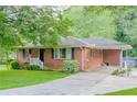 Attractive brick home featuring a well-maintained lawn, charming front steps, and covered side entry at 2194 Freydale Se Rd, Marietta, GA 30067
