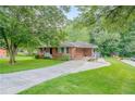 Single story brick home with driveway, covered parking, and spacious front lawn at 2194 Freydale Se Rd, Marietta, GA 30067