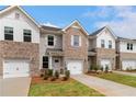 Elegant townhome exteriors with brick and siding, offering a blend of classic design and modern comfort at 353 Navigator Ln, Mcdonough, GA 30253