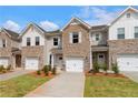 Attractive townhome exteriors showcase brick and siding accents, creating a modern and inviting curb appeal at 353 Navigator Ln, Mcdonough, GA 30253