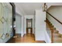 Inviting foyer features hardwood floors, staircase, and a decorative glass front door, enhancing the home's elegance at 3559 Turtle Cove Se Ct, Marietta, GA 30067
