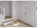Bright entryway features durable floors, fresh white paint, and stairs leading to the upper level at 1069 Alford Rd, Lithonia, GA 30058