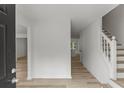 Inviting entryway with wood-look flooring, complemented by fresh neutral paint and stairs to the second level at 1069 Alford Rd, Lithonia, GA 30058