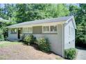 Charming single story home with brick exterior and landscaped front yard nestled among mature trees at 1834 Buckeye Sw St, Atlanta, GA 30310