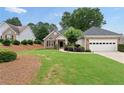 Attractive home with a combination brick and siding front, lush landscaping, and an attached two-car garage offering curb appeal at 3549 Daventry Nw Ln, Kennesaw, GA 30144