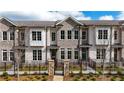 Attractive brick townhome with black iron fence and stone gate posts at 606 Goldsmith Ct # 114, Johns Creek, GA 30022
