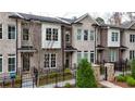Well-maintained brick townhomes with charming black iron fences at 606 Goldsmith Ct # 114, Johns Creek, GA 30022