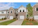 Beautiful brick townhouse exterior with a well maintained lawn and private driveway at 357 Navigator Ln, Mcdonough, GA 30253