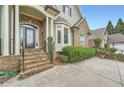 Inviting front entrance with stone steps, stately columns, and decorative glass front door at 1025 Ector Nw Dr, Kennesaw, GA 30152