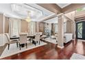 Open-concept living and dining area with hardwood floors, elegant décor, and natural light, perfect for entertaining at 1146 Simonton Peak Way, Lawrenceville, GA 30045