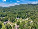 This home is nestled within a canopy of trees, and enjoys views of the surrounding mountains at 1725 Mountainside Dr, Cumming, GA 30040
