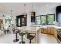 Modern kitchen with an island, stainless steel appliances, stylish pendant lights, and large windows at 3960 Clairmont Rd # 2, Chamblee, GA 30341