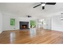 Bright living room with a brick fireplace, hardwood floors, and large windows overlooking the backyard at 1780 Kinridge Rd, Marietta, GA 30062