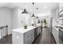 Modern kitchen with stainless steel appliances, white countertops, dark wood floors, and seamless flow to living area at 3933 Danube Ln # 224, Atlanta, GA 30339