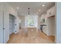 Modern kitchen with white cabinets, stainless steel appliances, a large island, and pendant lighting at 1919 Deco Dr, Kennesaw, GA 30144