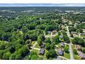 An aerial view of houses nestled among lush trees within a suburban neighborhood at 4745 Masters Ct, Duluth, GA 30096