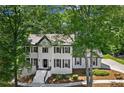 Beautiful two-story home with painted brick, black shutters and mature trees at 4745 Masters Ct, Duluth, GA 30096