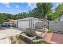 Backyard features a brick pathway, stone waterfall, and patio area, creating a serene outdoor space at 935 Bobcat Se Ct, Marietta, GA 30067