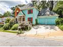 Charming two-story home with blue siding, red shutters, and a two-car garage at 105 Bruton St, Decatur, GA 30030