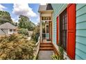 Inviting front porch with brick steps, white railings, and red shuttered windows at 105 Bruton St, Decatur, GA 30030