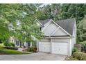 Well-maintained home with a two-car garage, complemented by mature trees and a neatly landscaped yard at 2429 Brookgreen Nw Commons, Kennesaw, GA 30144