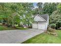 Spacious home showcasing a long driveway, lush greenery, and an attached two-car garage for ample parking at 2429 Brookgreen Nw Commons, Kennesaw, GA 30144
