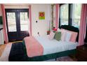 Main bedroom boasts a plush bed, stylish decor, and access to a private outdoor space at 3236 Jonesboro Rd, Atlanta, GA 30354