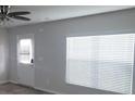 Bright living room featuring a ceiling fan, large window, and a glass door at 3484 Enterkin Ln, Atlanta, GA 30349