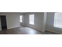 Open concept living room featuring neutral walls and modern wood-look flooring at 3484 Enterkin Ln, Atlanta, GA 30349
