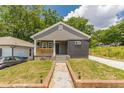 This renovated home features a cozy front porch and a brick walkway, blending classic charm with modern updates at 299 Fletcher Sw St, Atlanta, GA 30315
