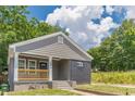 A delightful single-Gathering house features a newly renovated facade, front porch, and well-manicured lawn at 299 Fletcher Sw St, Atlanta, GA 30315
