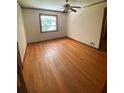 Bedroom with hardwood floors, ceiling fan, window, and neutral walls at 1024 Magnolia Dr, Smyrna, GA 30082