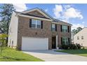 Attractive two-story brick home with a spacious two-car garage and well-maintained front yard at 450 Noblewood Dr, Mcdonough, GA 30252